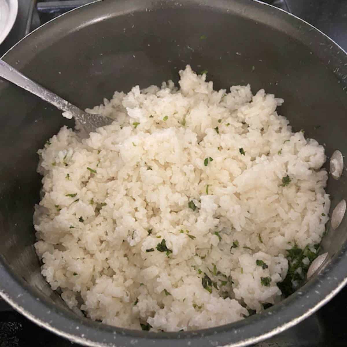 Fluffing rice in pot.