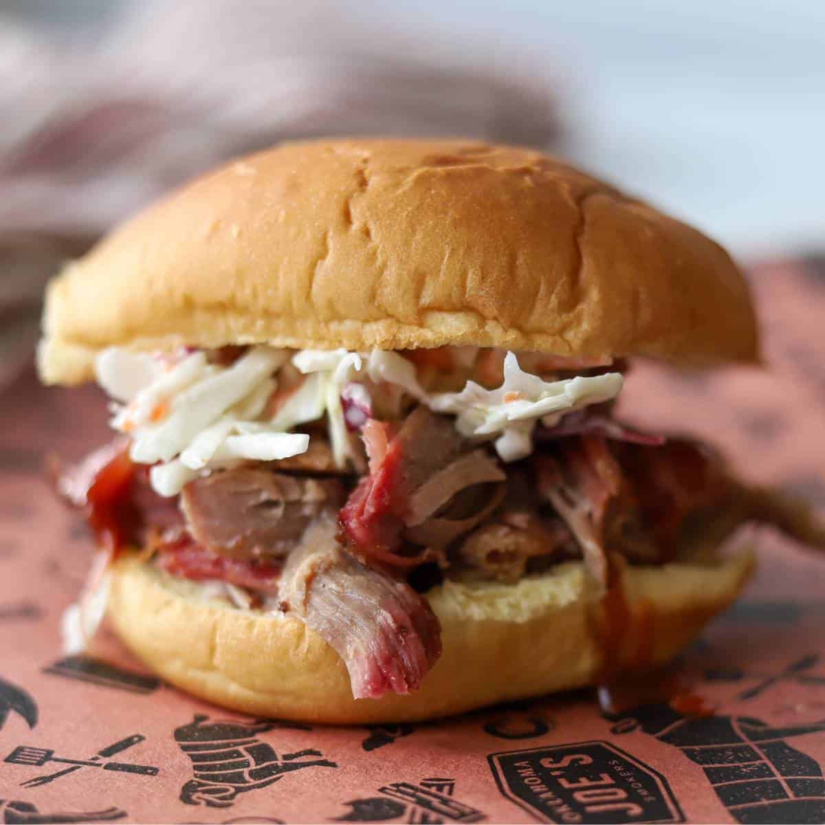 Pulled pork sandwich loaded with coleslaw.