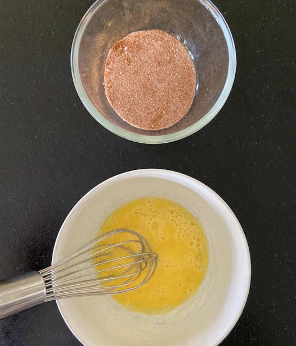 Cinnamon sugar in one bowl and egg wash in another.