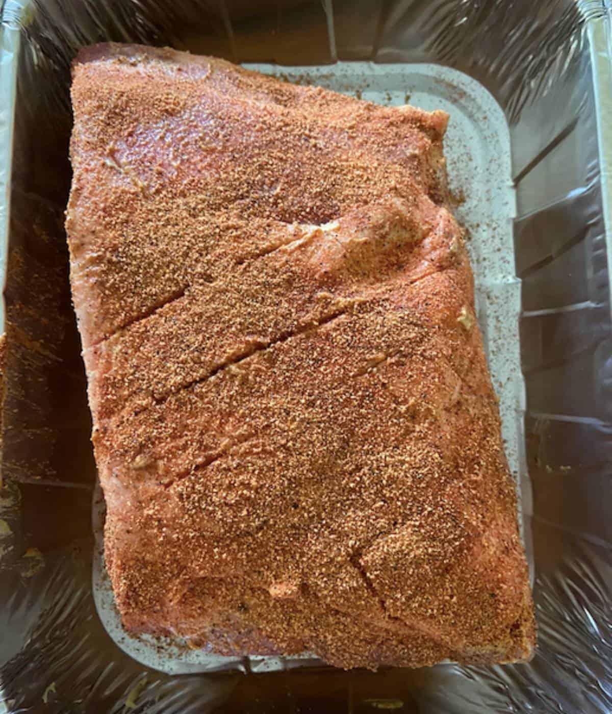 Pork butt coated in dijon mustard then covered with seasoning.