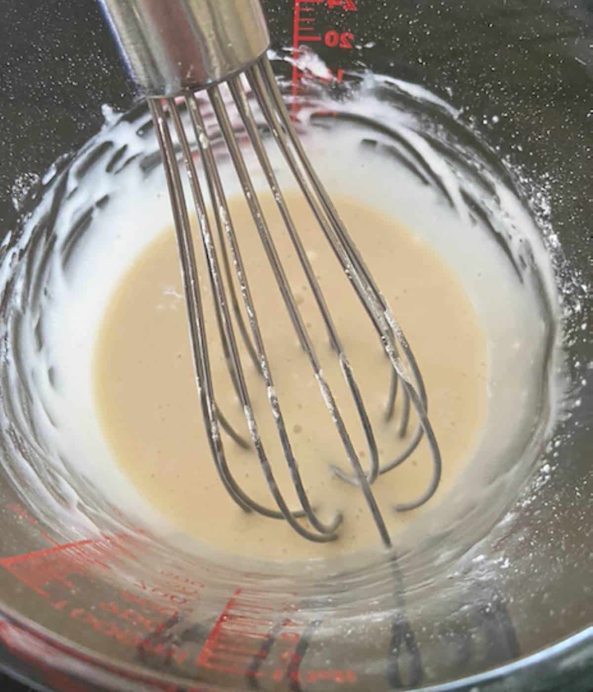 Vanilla icing in pyrex dish.
