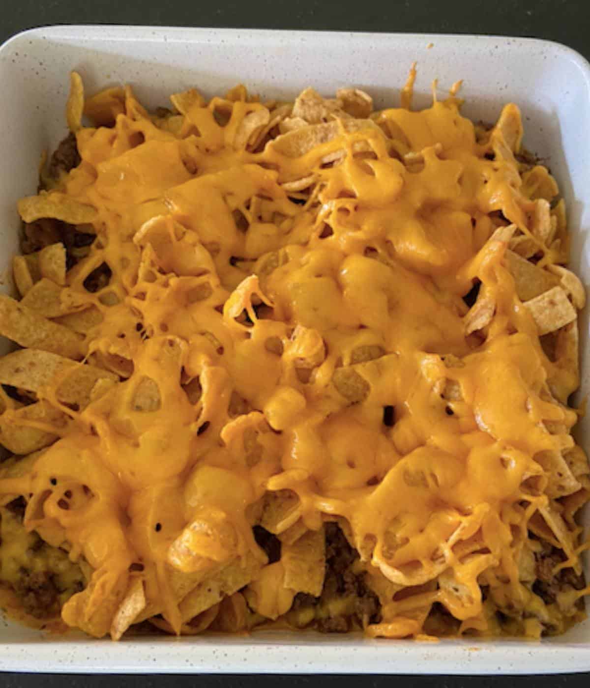 Walking taco casserole with melted cheese topping.