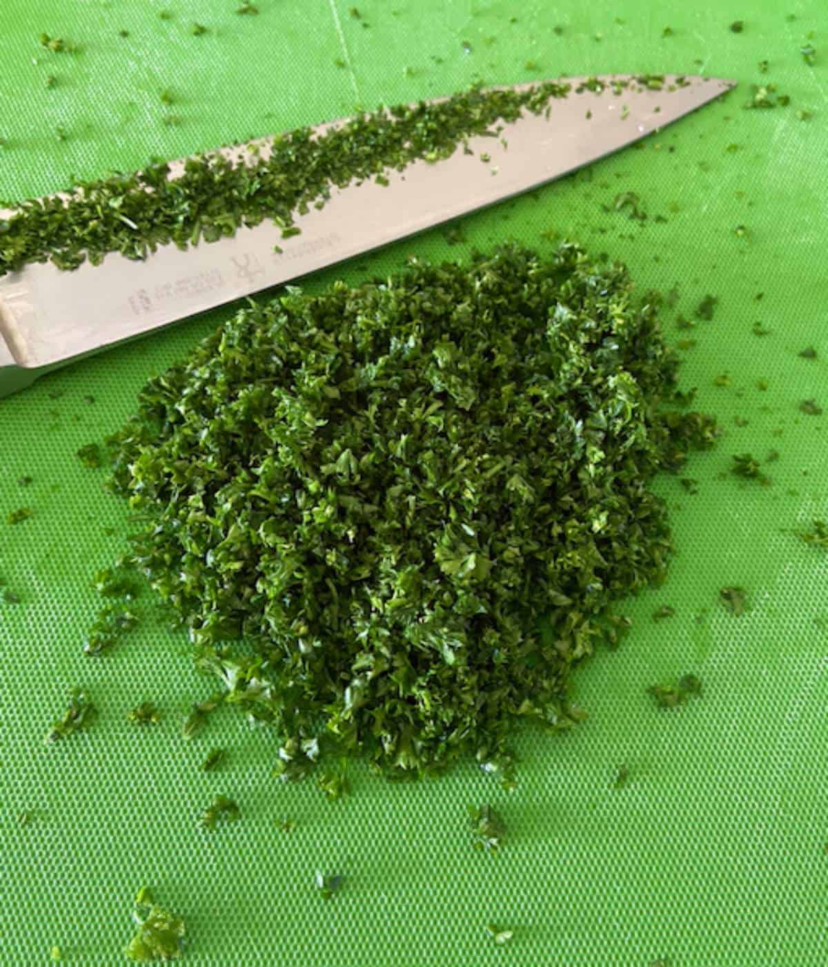 Minced parsley on cutting board.