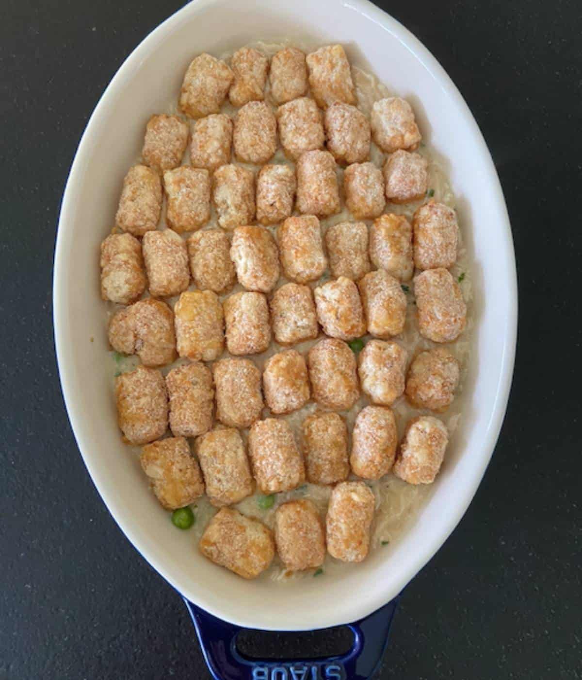 Tater tots topped on casserole dish.