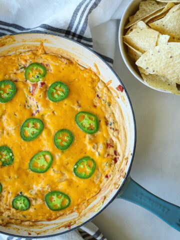 Jalapeno dip in skillet with tortilla chips.