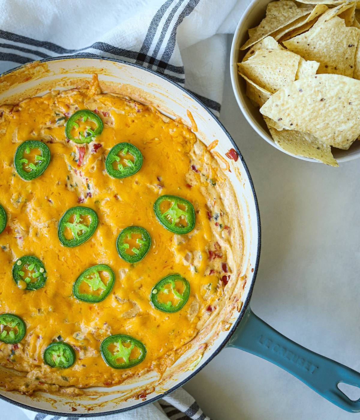 Jalapeno dip in skillet with tortilla chips. 