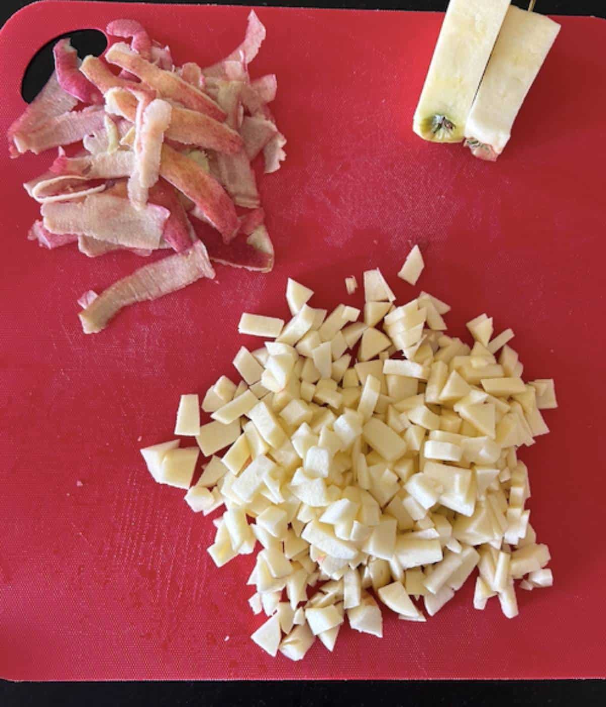 Apples peeled and diced on cutting board.