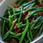 Crack green beans topped with bacon in casserole dish.