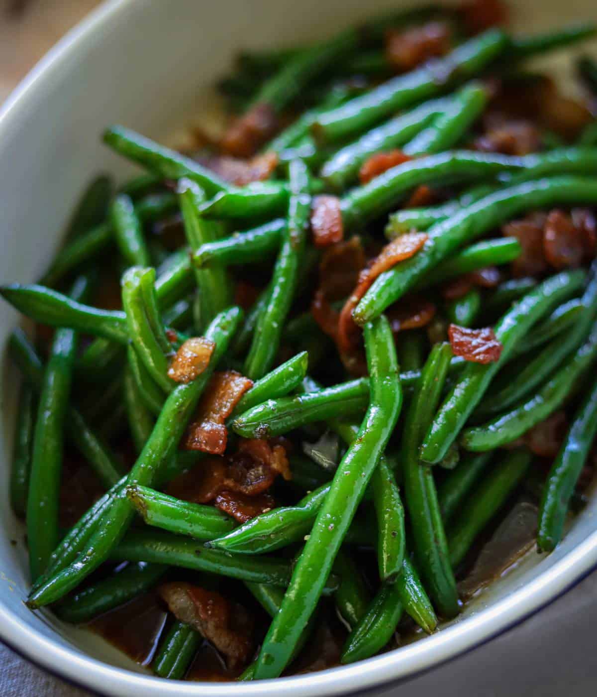 Crack green beans topped with bacon in casserole dish. 