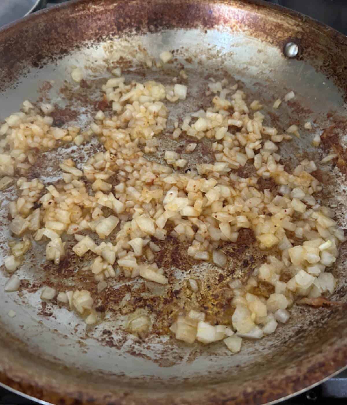 Onions sautéing in pan.