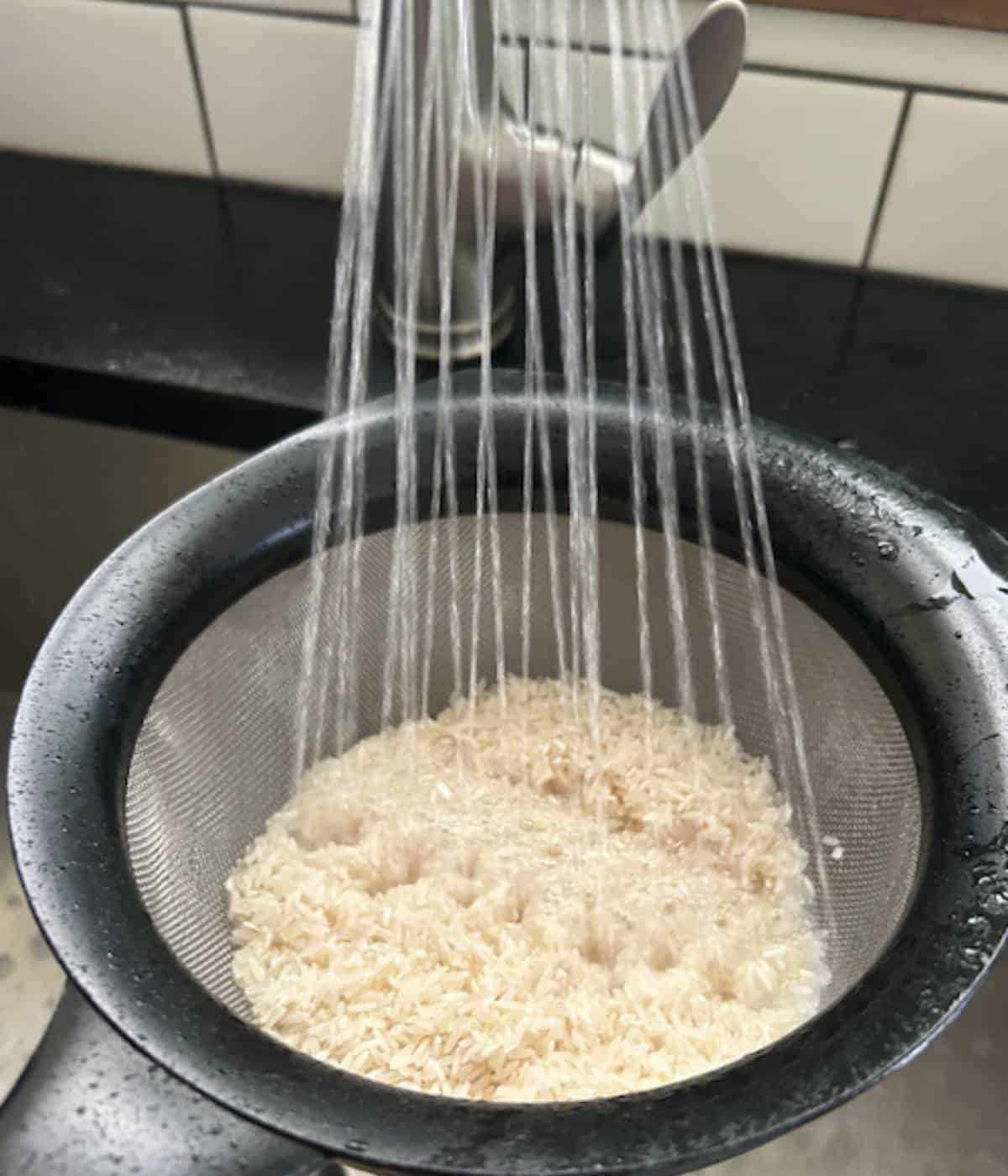 Rinsing rice in colander.