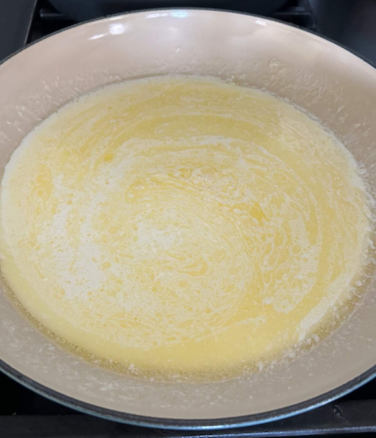 Heavy cream and butter for alfredo in skillet.