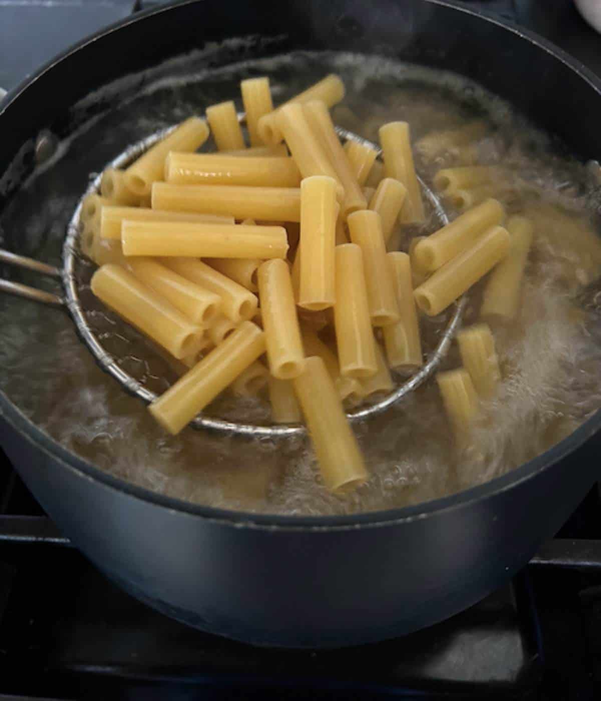Ziti cooking in boiling water.