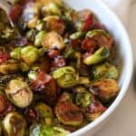 Caramelized Brussels sprouts in bowl with bacon.