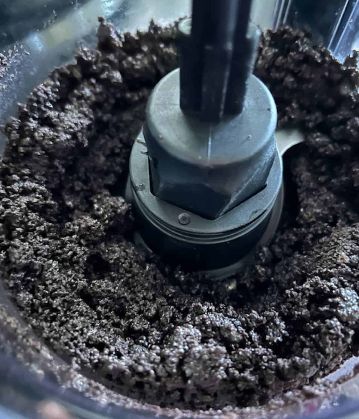 Oreo crumbles with butter in food processor.