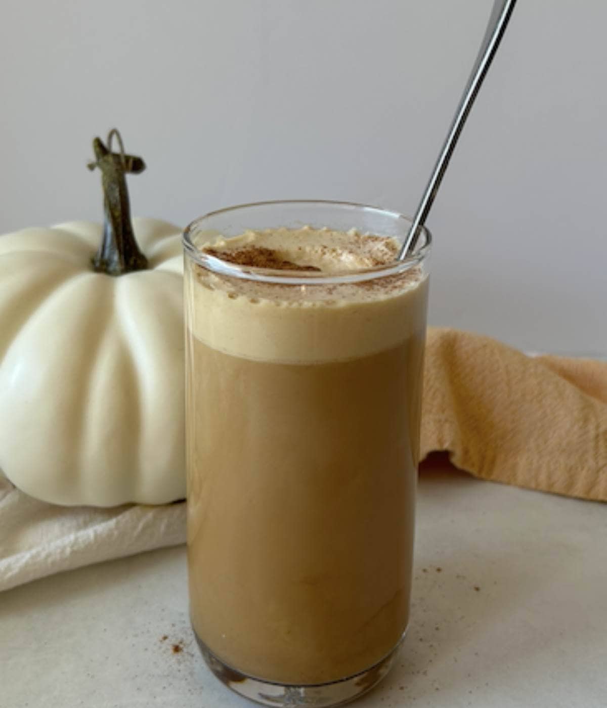 Pumpkin cold foam topped on cold brew coffee in glass. 