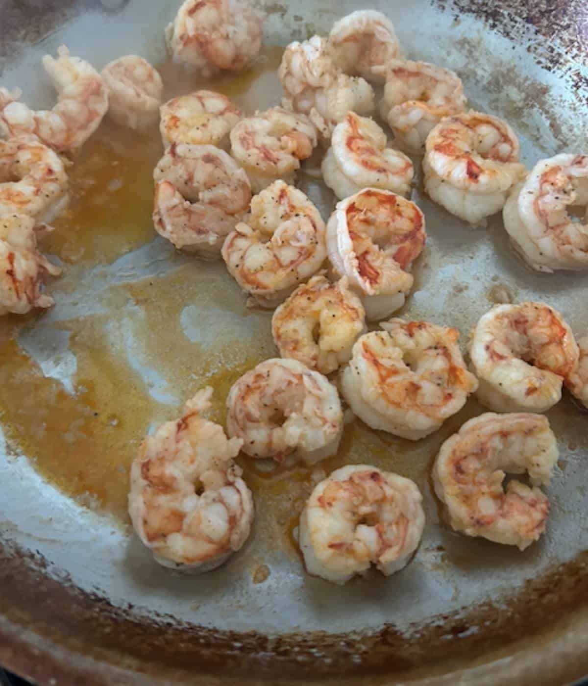 Shrimp searing in pan.