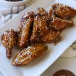 Garlic soy chicken wings on white plate.
