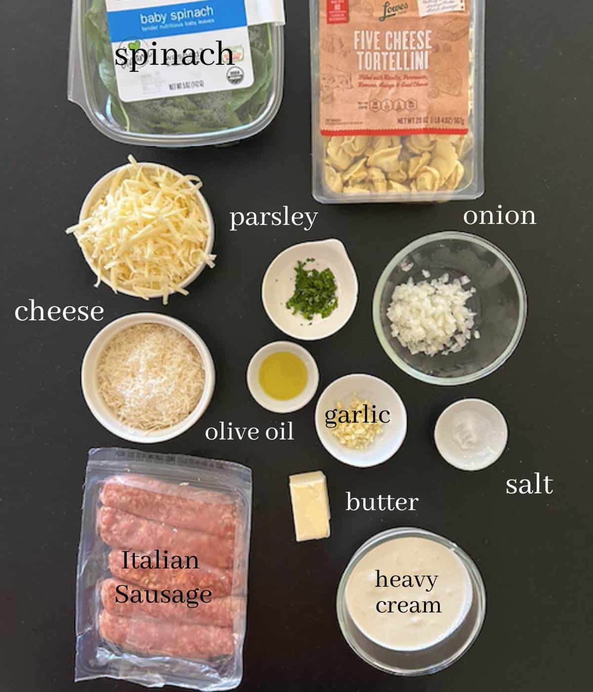 Ingredients for tortellini alfredo on countertop.
