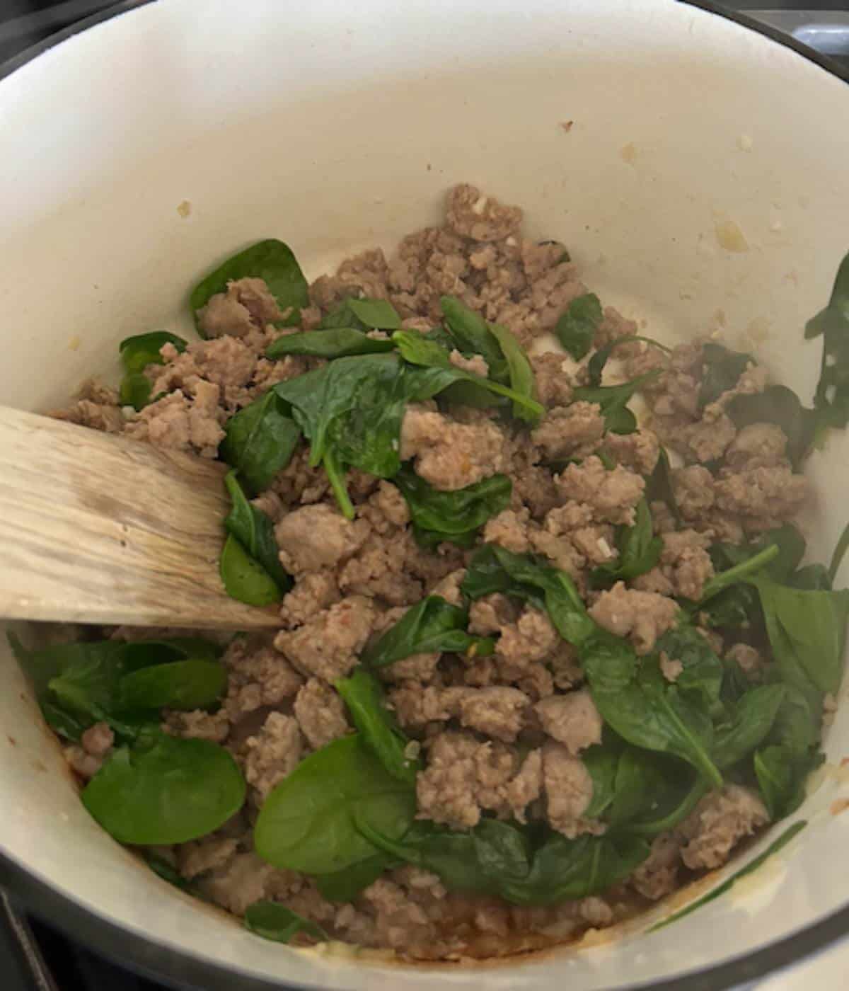 Spinach added to sausage.