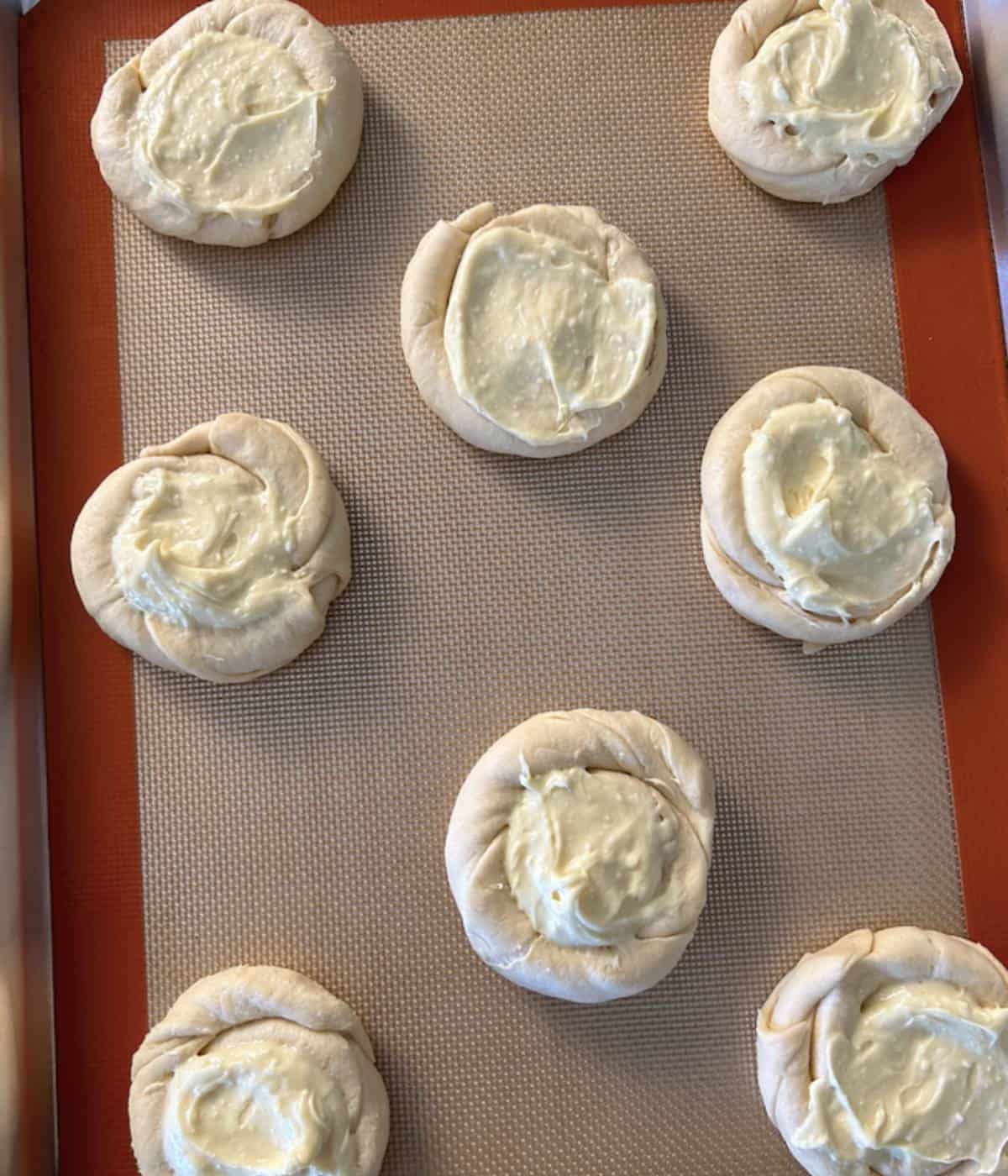 Pillsbury Cream cheese danish with filling on cookie sheet.