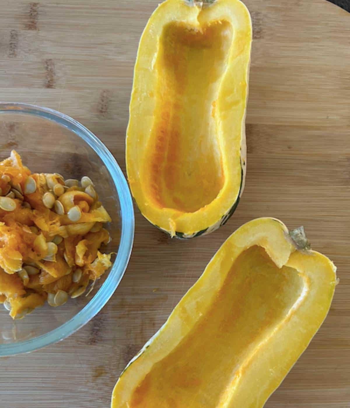 Delicata squash cut in half with seeds removed.