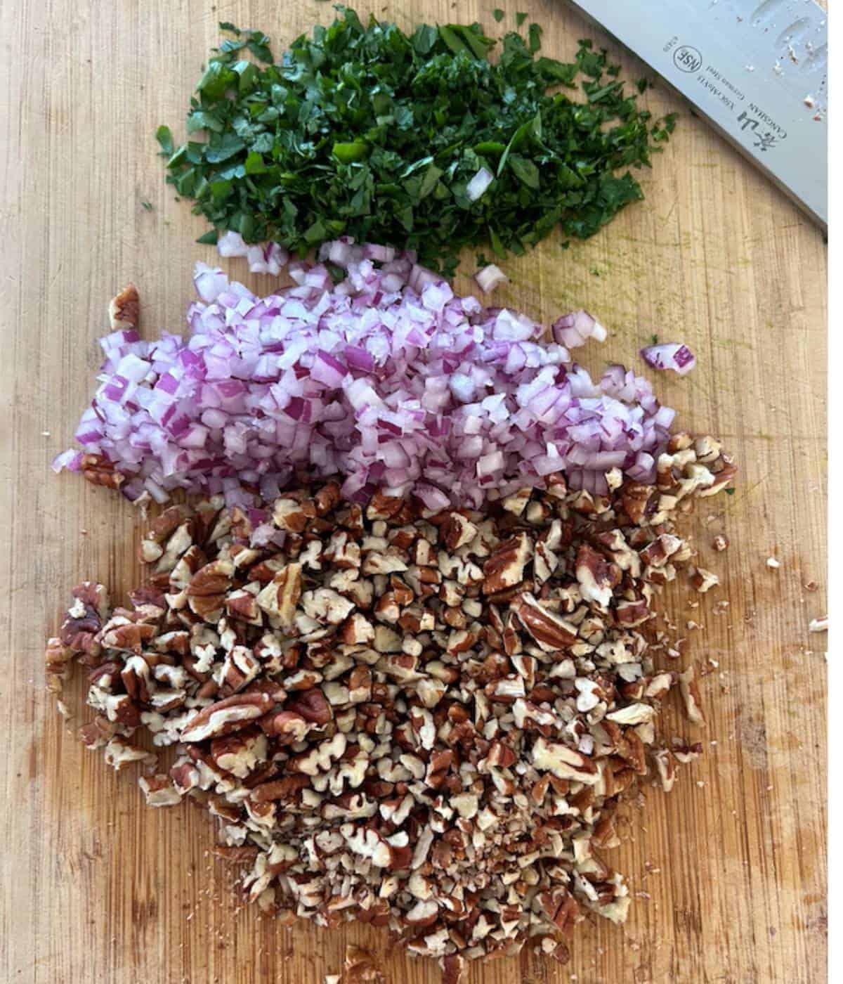 Finely chopped ingredients on cutting board.