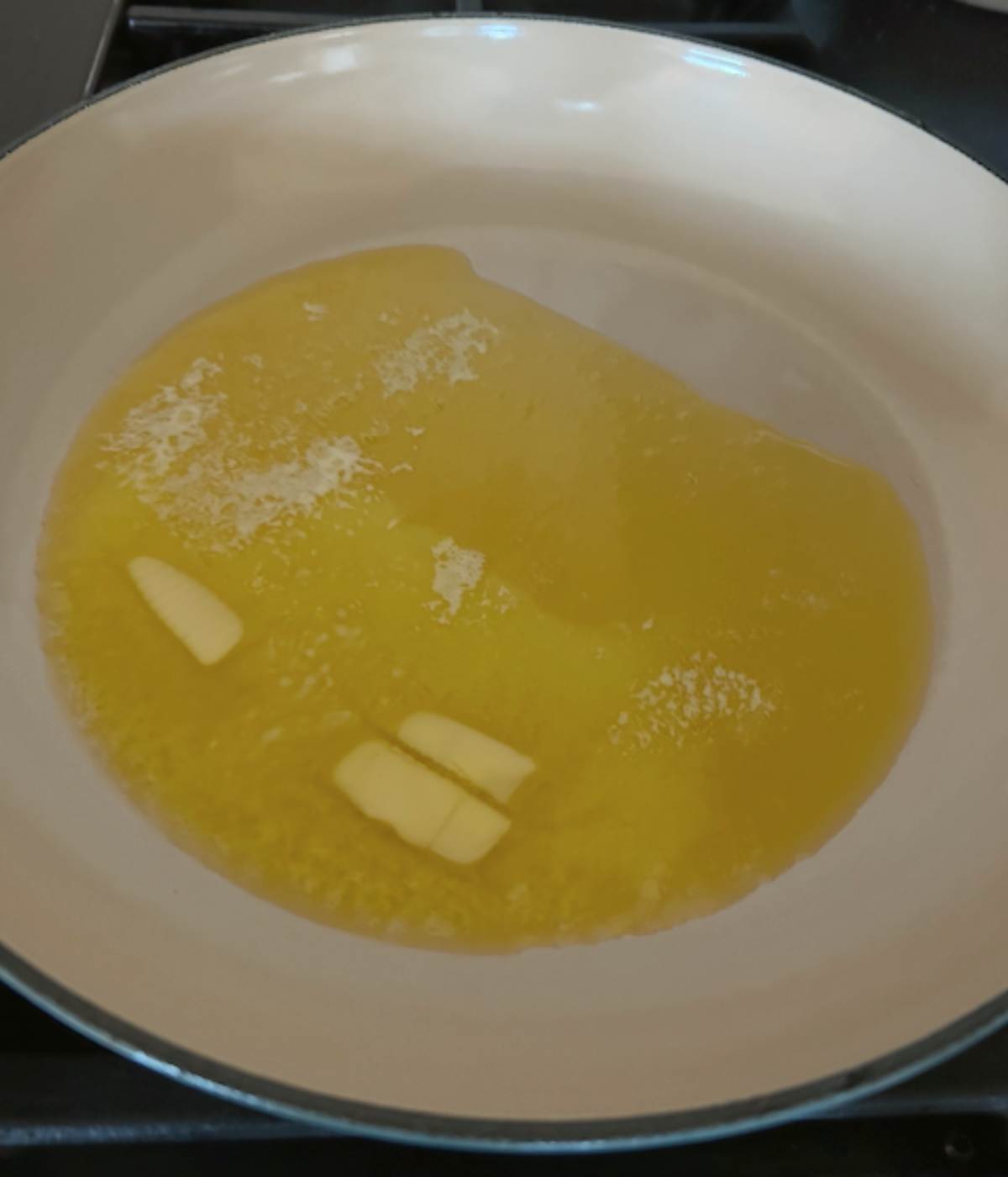 Melted butter in skillet.