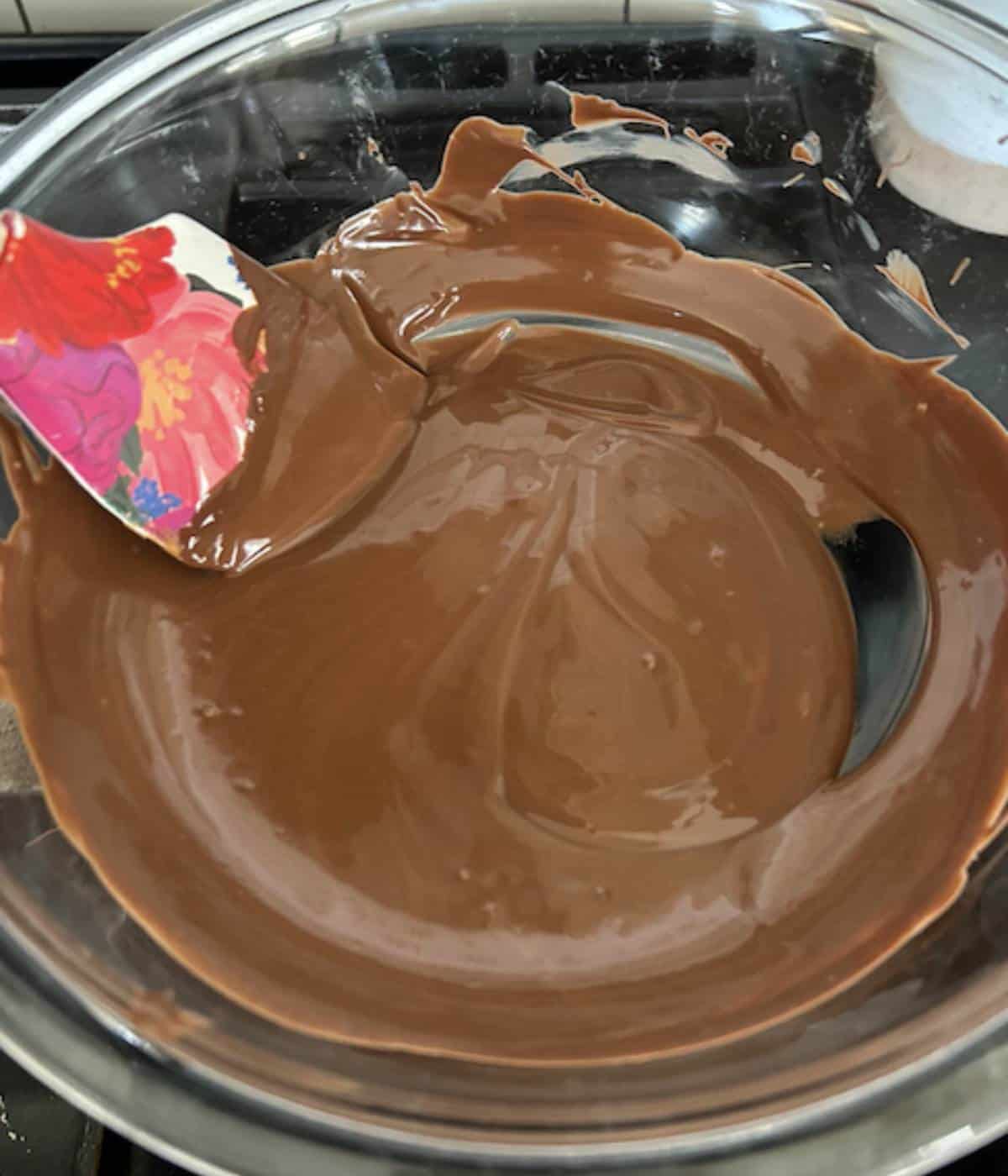 Chocolate and peanut butter melted in glass bowl.