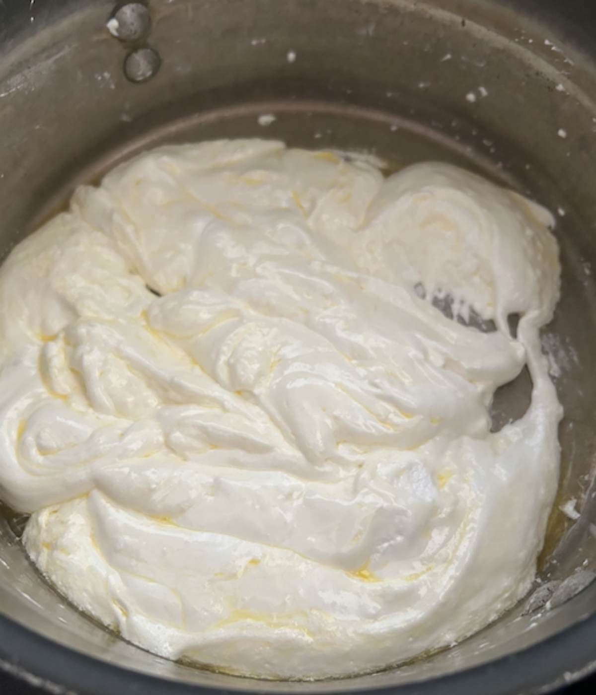 Marshmallow cream fluff in pot with butter.