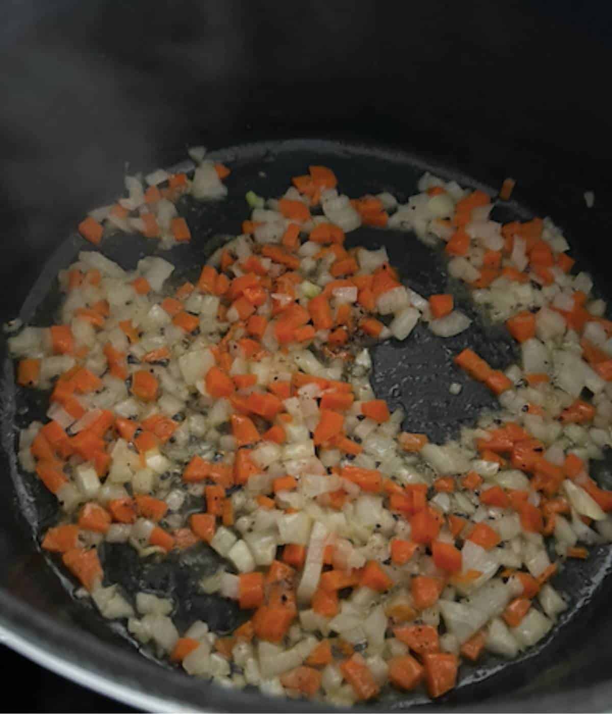 Vegetables softening in dutch oven.