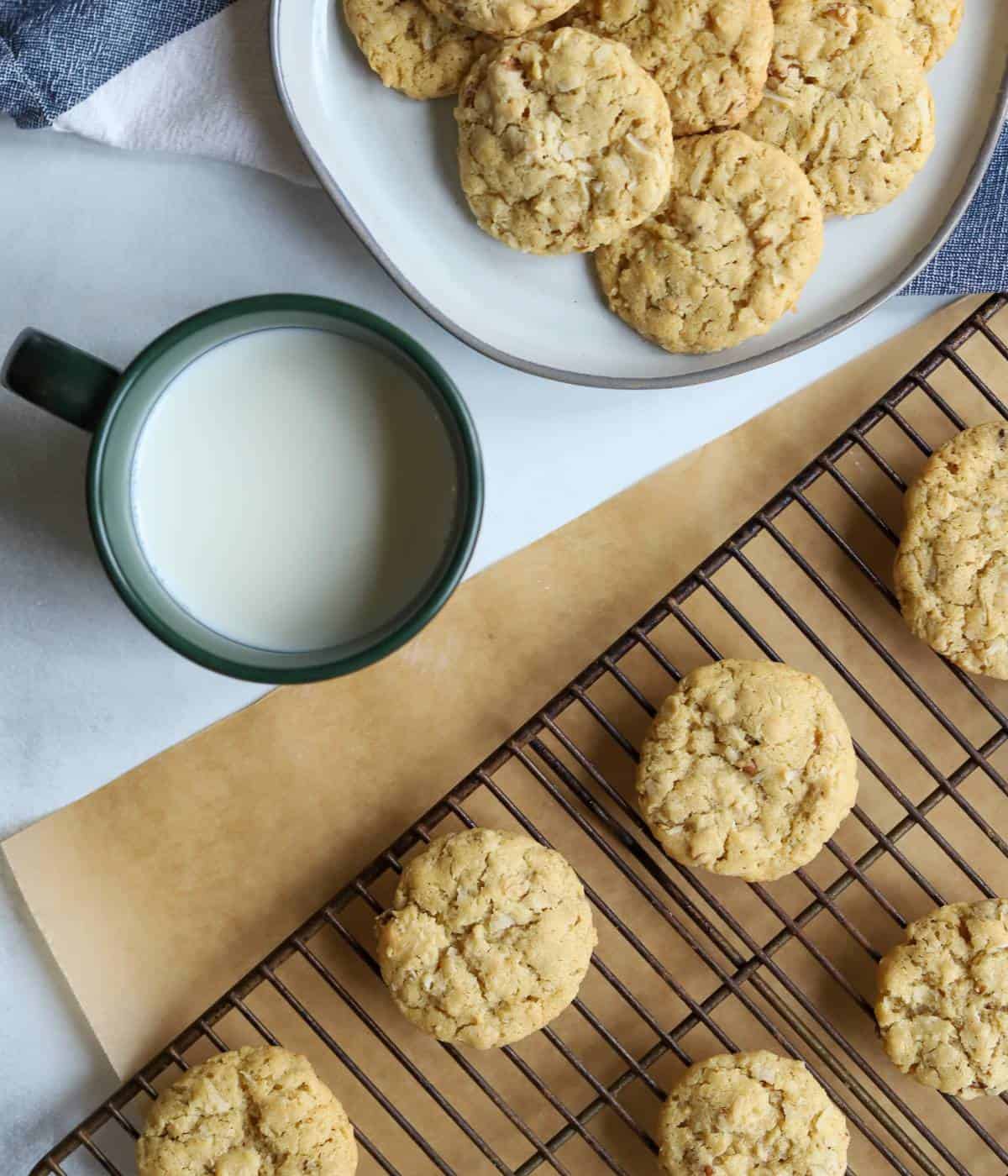 Coconut pecan cookies on rack and plate with milk. 