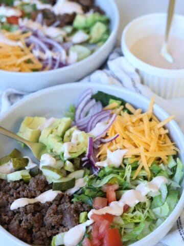 Cheeseburger bowls topped with chipotle ranch dressing.