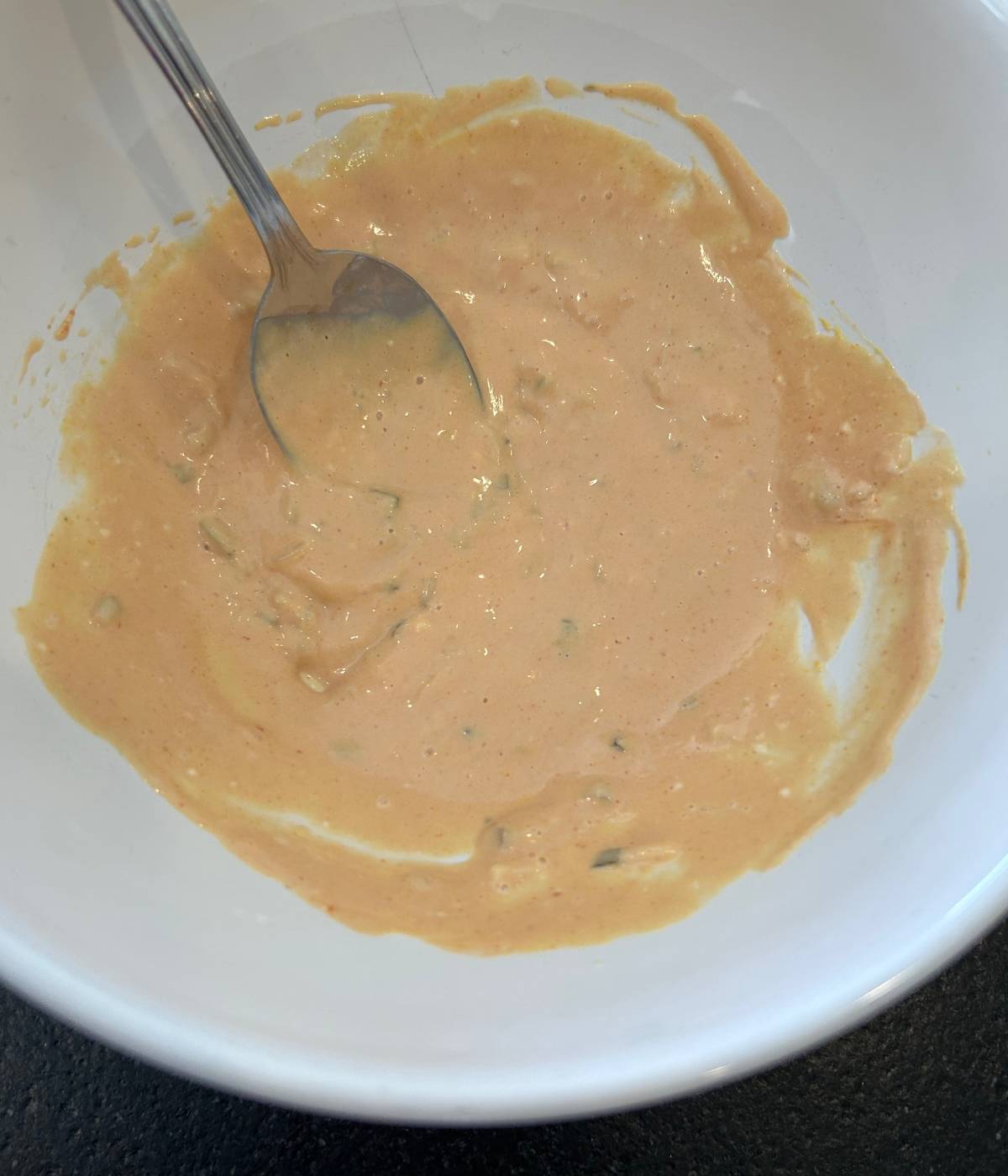 Cheeseburger slider sauce in bowl with spoon.
