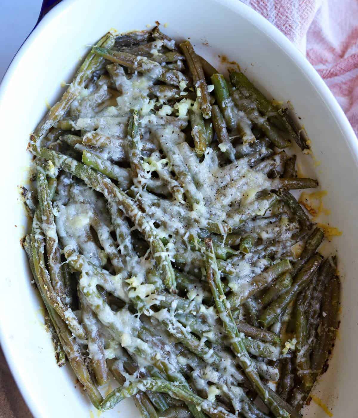Parmesan covered green beans in casserole dish.