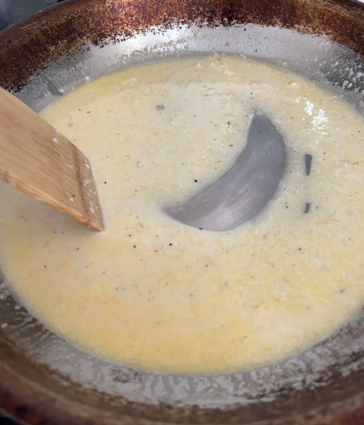 Creamy lemon pasta sauce with parmesan in skillet.