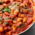 Marinara gnocchi with parmesan cheese in skillet.