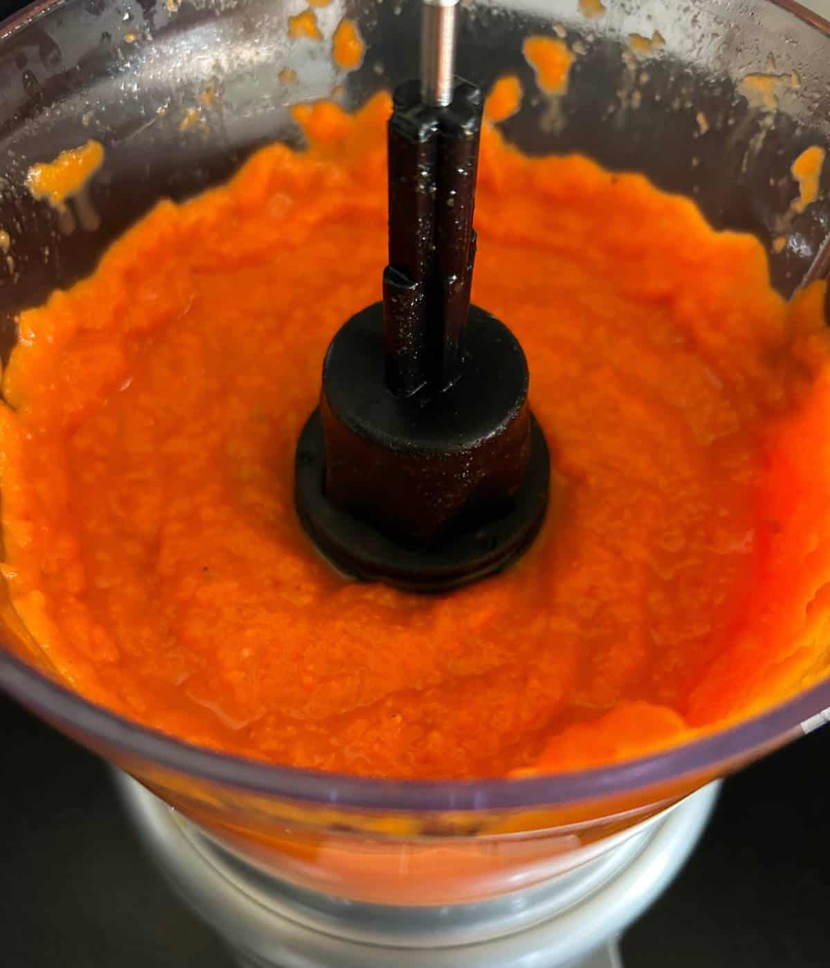 Pureed carrots and vegetables in food processor.