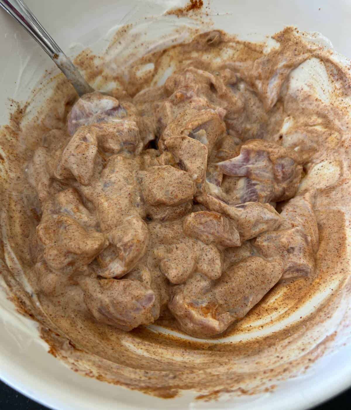 Yogurt marinade for chicken tikka masala in bowl.