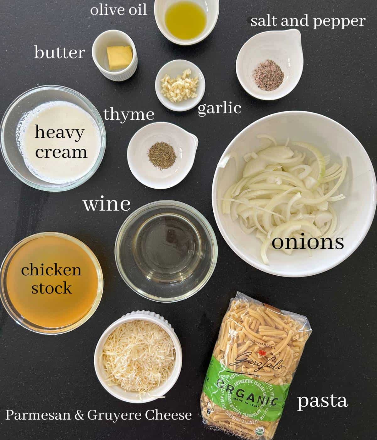 Ingredients for French onion soup pasta on countertop.