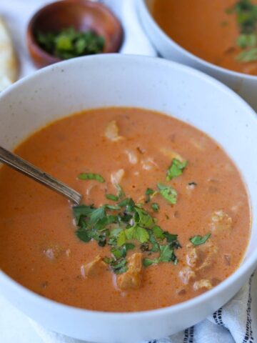 Tikka Masala Soup topped with cilantro in bowl.