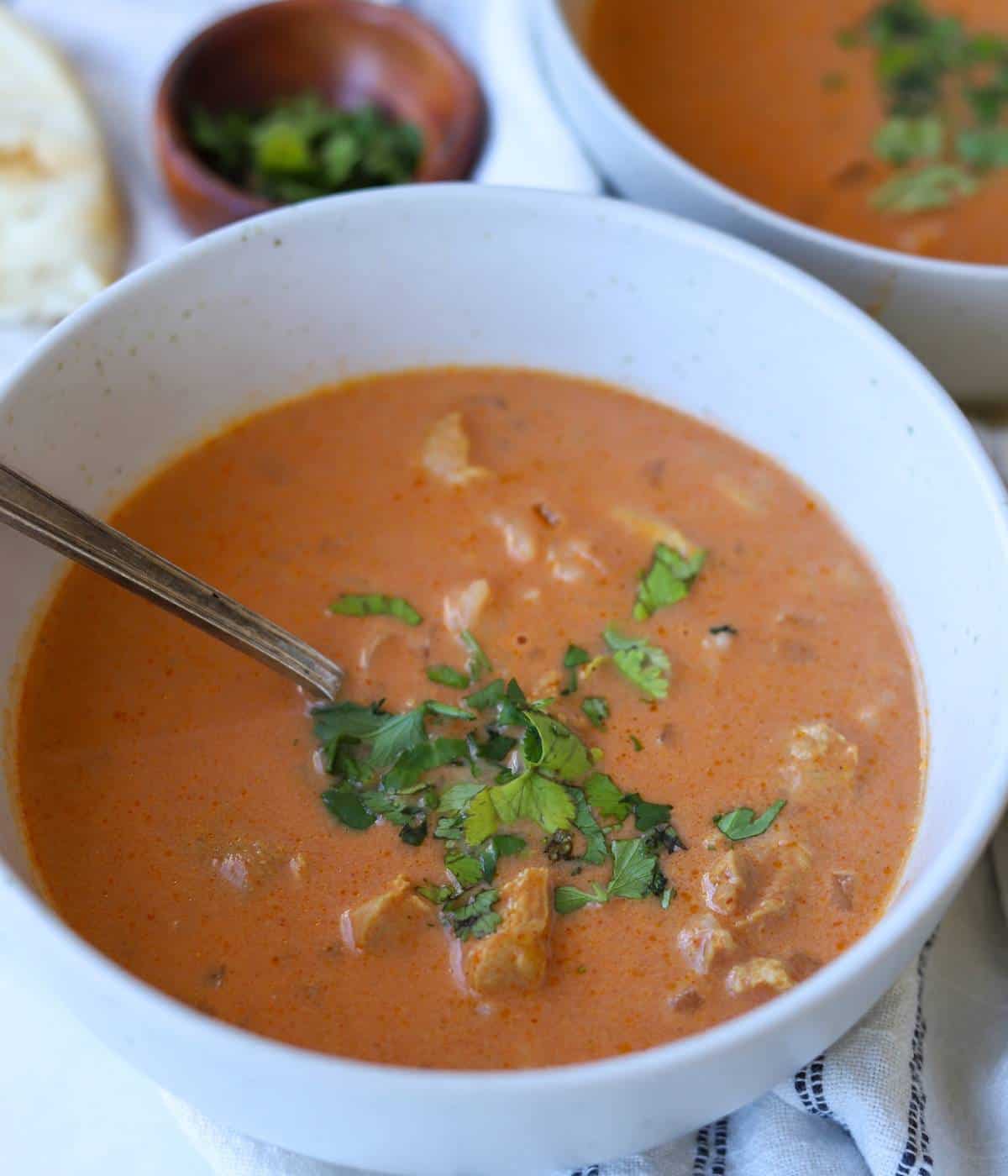 Tikka Masala Soup topped with cilantro in bowl.