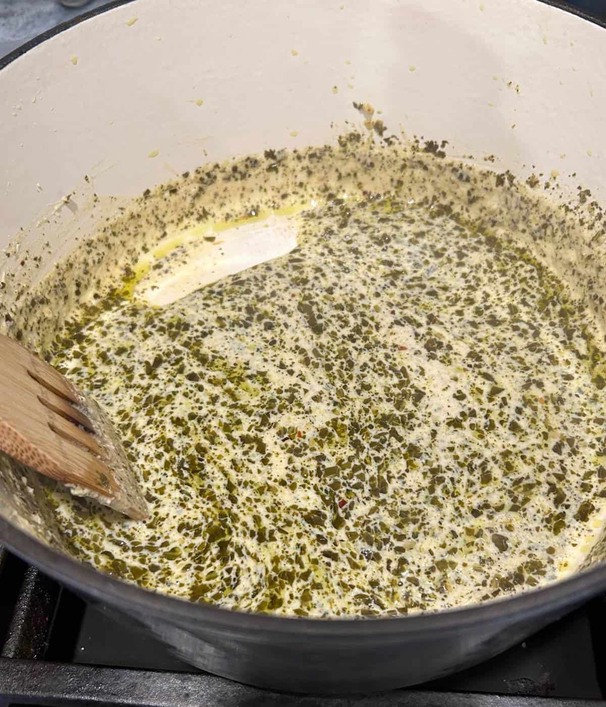 Creamy pesto ricotta sauce in dutch oven.