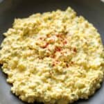 Egg salad topped with paprika.