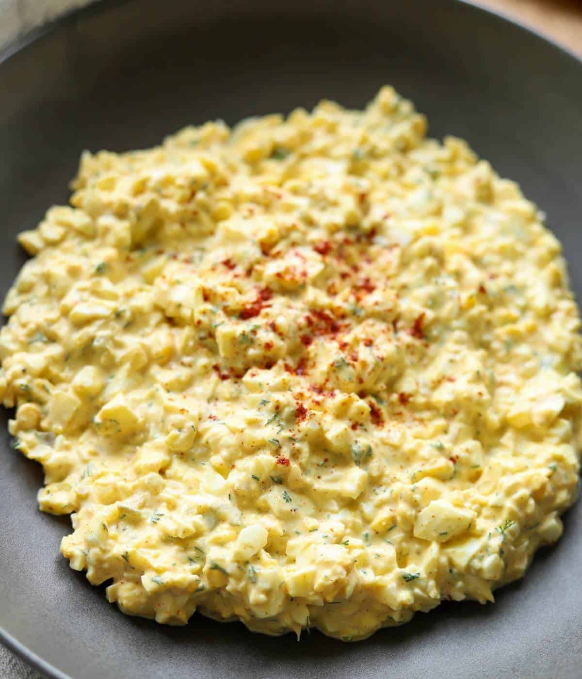 Egg salad topped with paprika.