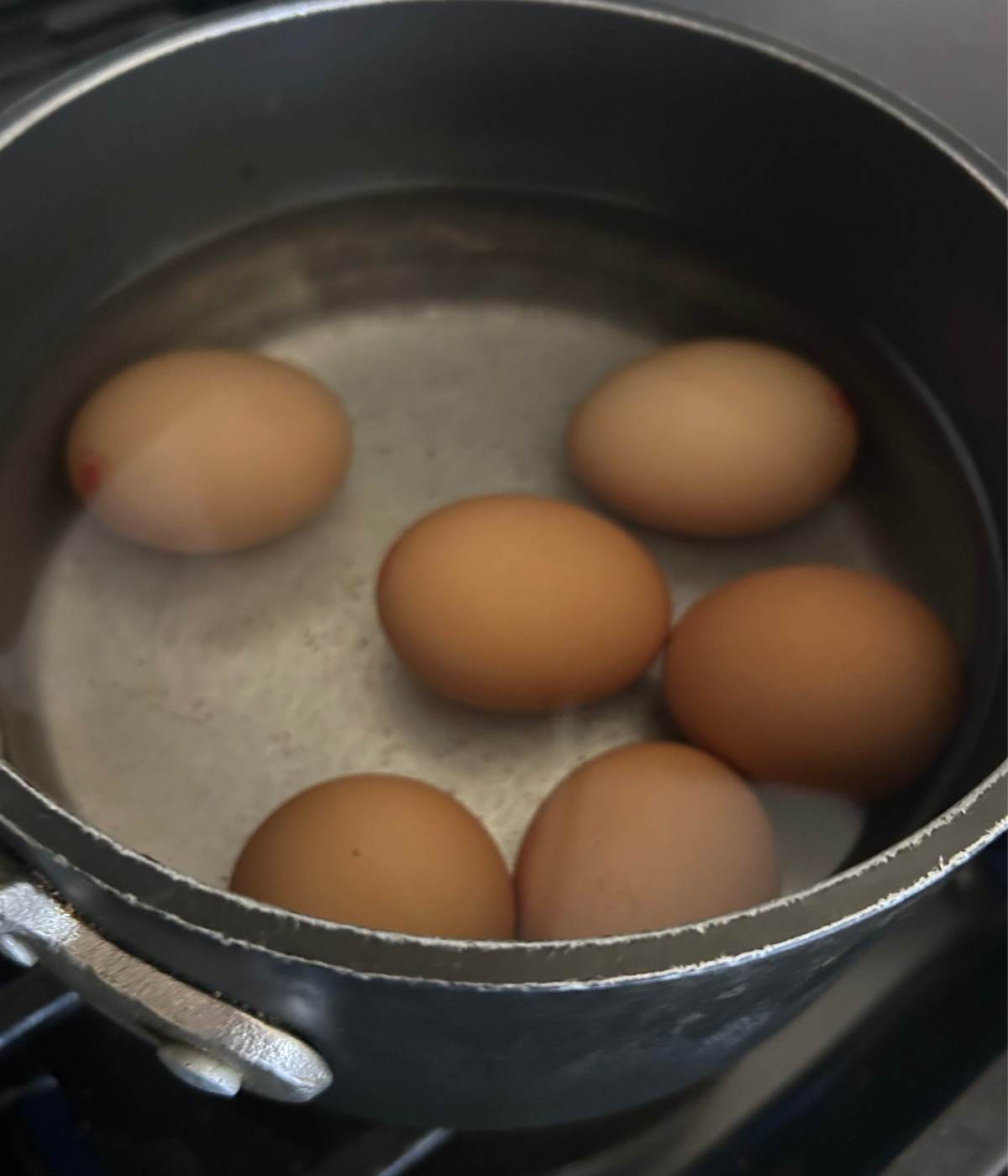 Hard boiled eggs in pot with water.