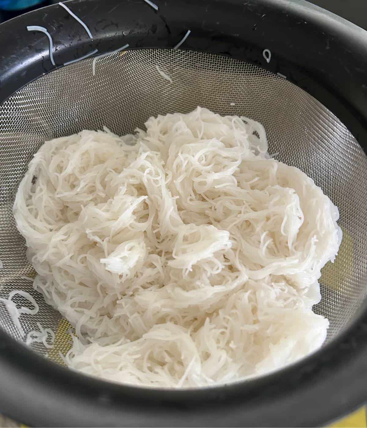 Straining rice noodles.