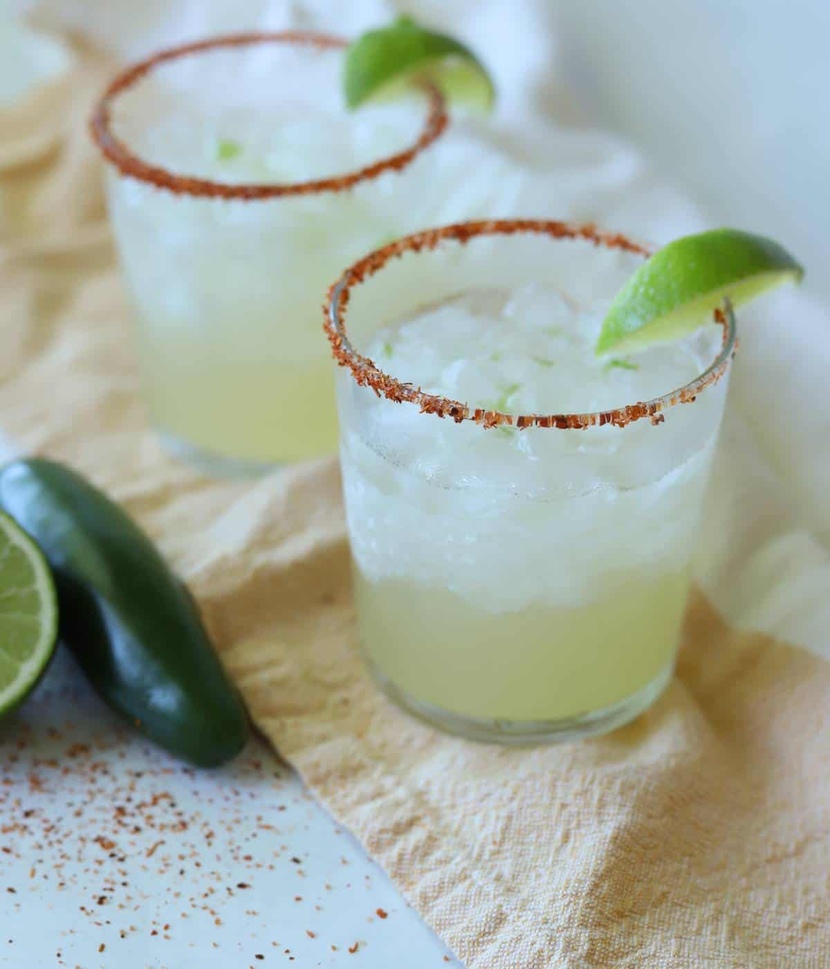 Lime margaritas with Tajín rim and lime wedges. 