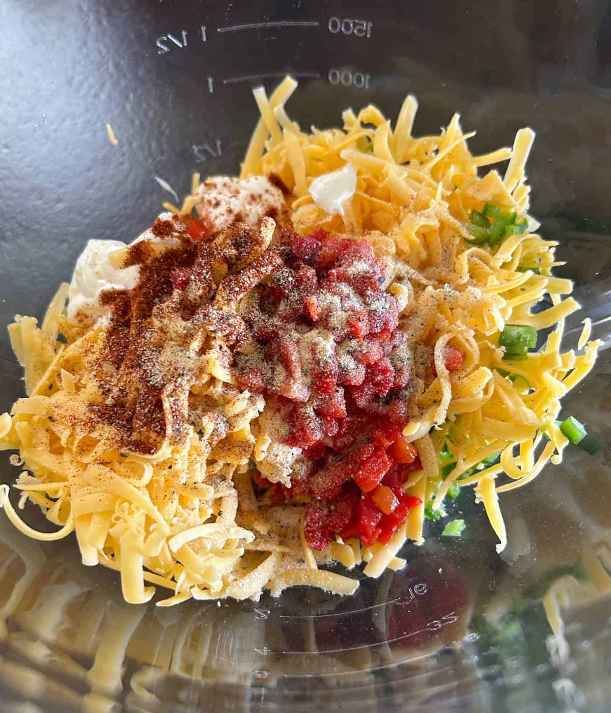 Ingredients for pimento cheese in bowl.