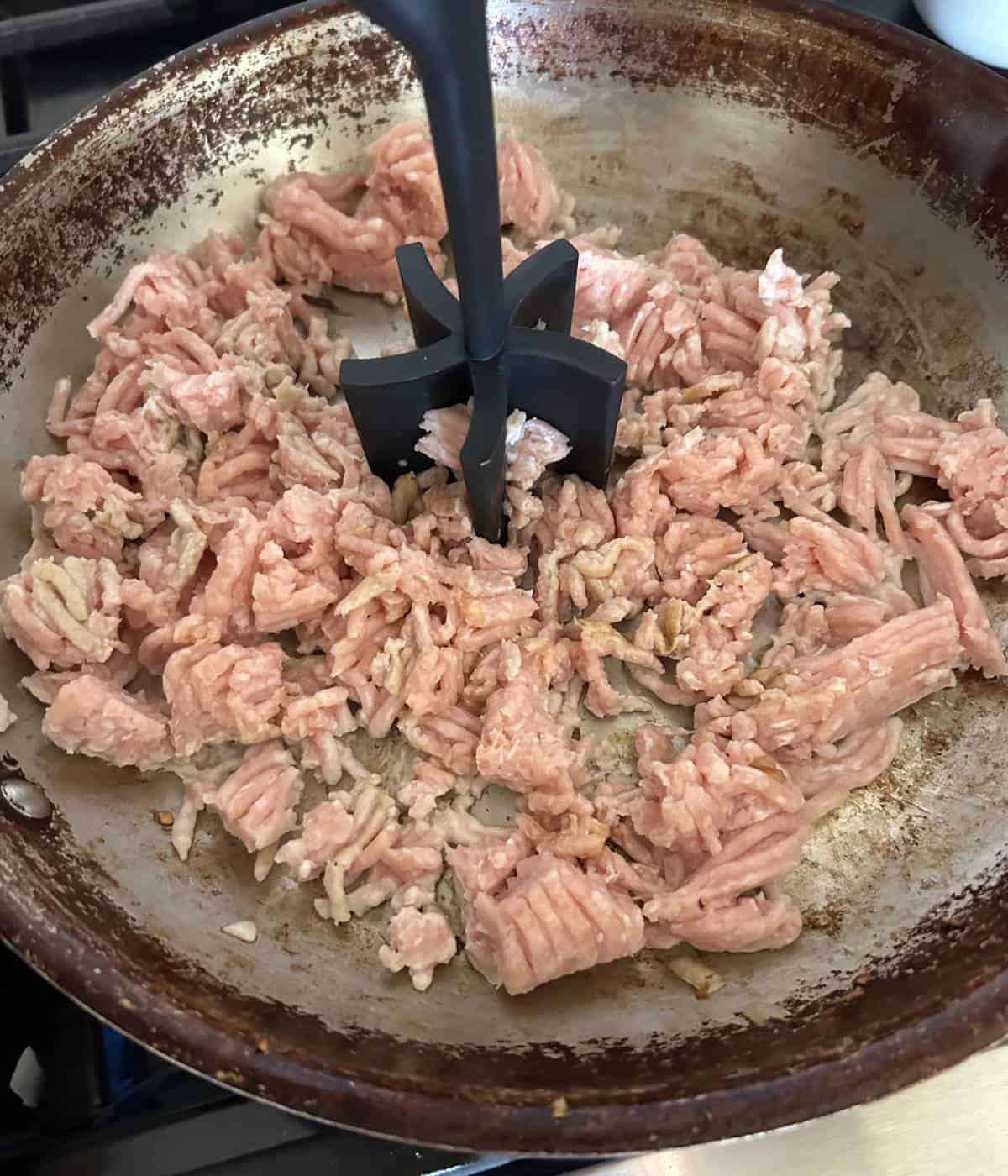 Ground chicken with meat chopper.